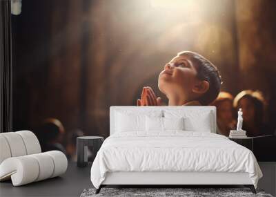 portrait of little boy with a prayer in the hands Wall mural