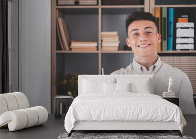 Portrait of one young and happy cheerful man smiling looking at the camera having fun. Headshot of male person working at home in the office.. Wall mural