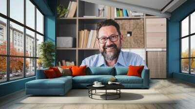 Portrait of one young and happy cheerful man smiling looking at the camera having fun. Headshot of male person working at home in the office.. Wall mural