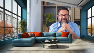 Portrait of one young and happy cheerful man smiling looking at the camera having fun. Headshot of male person working at home in the office.
 Wall mural