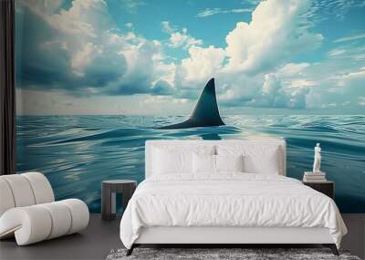 shark fin on surface of ocean agains blue cloudy sky Wall mural