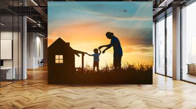 Silhouette of a happy family at sunset. A child, mom Wall mural