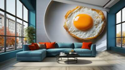 Single fried egg on white plate, minimalist composition. Wall mural