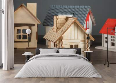 Small wooden decorative houses on table, studio background Wall mural