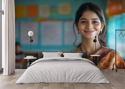 Smiling Young Indian Woman Teacher in saree Stands at School Classroom. Wall mural