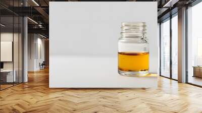 test jar with transparent yellowish liquid, white background Wall mural