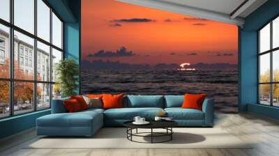 The red sun sets in the sea Wall mural