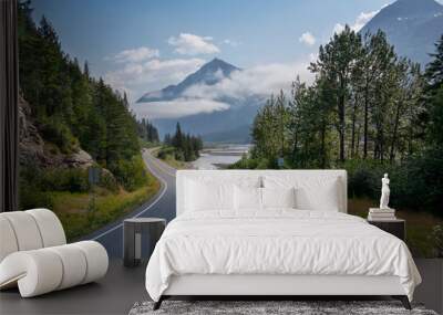 Camper travels along a curving highway in Alaska below mountains near Seward on a sunny afternoon Wall mural