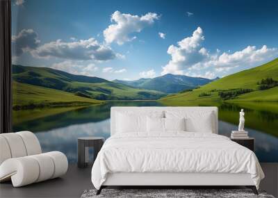 tranquil mountain landscape with calm lake and reflections lush green hills under a serene blue sky with scattered clouds Wall mural