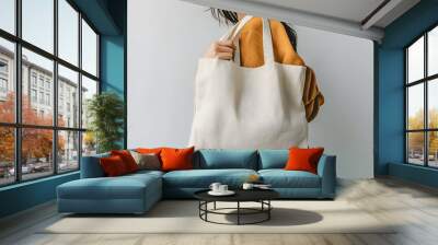 Woman is holding bag canvas fabric for mockup blank template. Wall mural