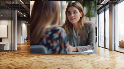 Young professional business woman executive hr manager having job interview or business discussion with female applicant holding cv sitting at workplace in corporate office meeting. Wall mural