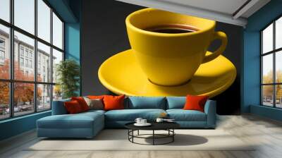 A coffee cup with a handle on top and saucer, with a dark background Wall mural