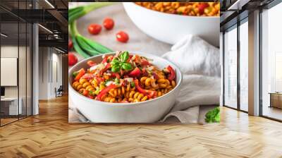 Pasta salad with red pepper, tomatoes, spring onions and basil in a white bowl Wall mural