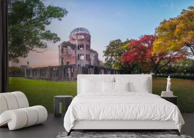 The Atomic Bomb Dome Panorama in Hiroshima and the surounding garden in autumn at sunset on the side of Motoyasu River in Japan, with the Peace Memorial Park on the left in the background. Wall mural