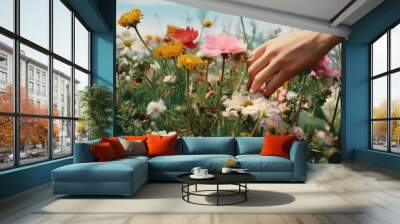 Wild flowers picking by hands at flower farm. Wall mural