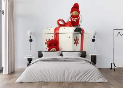 red gift box with ribbon and two Christmas wooden dolls with red hat. Wall mural