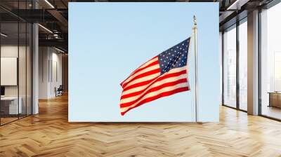 American National Flag Flitting in the Wind on Blue Sky BAckground Wall mural