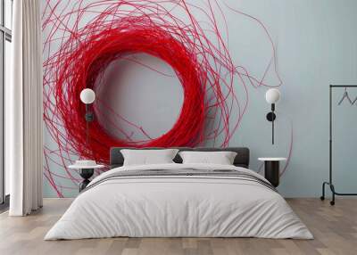 A nest of tangled red thread on a light gray background, minimalistic style, symbolizing connection and complexity, ideal for creative or abstract concepts. Wall mural