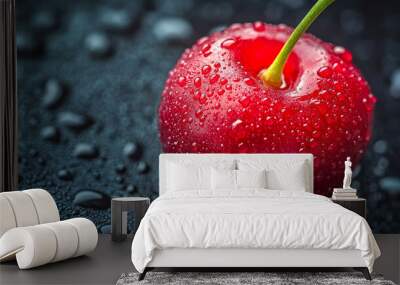 Single, ripe, red cherry sits on a dark surface, covered in water droplets Wall mural