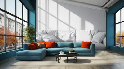 A comfortable sofa in light grey colors next to a bright window  Wall mural