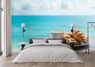 Croissants and a white cup of coffee on a white plate with a beautiful ocean in the background Wall mural