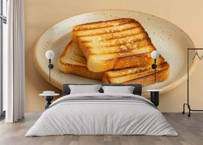 Toasted bread on a plate on a light beige background Wall mural