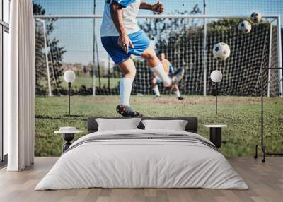 Sports, training and football player score a goal for challenge at a game or match at tournament. Fitness, exercise and back of soccer athlete kicking a ball at practice on outdoor field at stadium. Wall mural