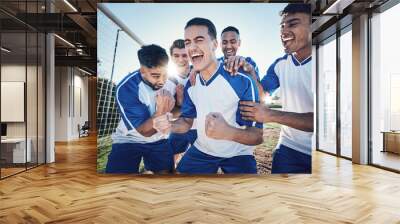 Winning, goal and soccer player with team and happiness, men play game with sports and celebration on field. Energy, action and competition with male athlete group, cheers and diversity with success Wall mural