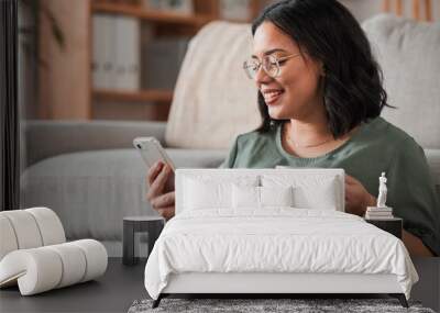 Woman, coffee and typing with phone in living room for social media post, reading notification or tech chat. Happy person, drinking tea and scroll on smartphone, download app and mobile games at home Wall mural