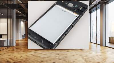 battery in a disassembled smartphone, battery replacement in wearable devices, lithium-ion battery charging cycles Wall mural