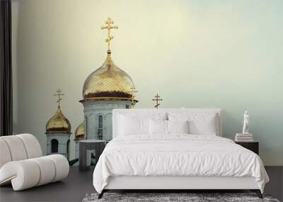 Christian church against the blue sky. Golden domes. Facade. Wall mural