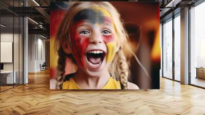 Little blond preschool girl watching soccer football cup. on public viewing. Girl with German flag on face Wall mural