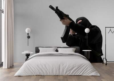 Man in mask With gun on white background Wall mural