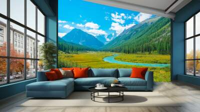 Serpentine river in valley before beautiful glacier. Snowy rocks behind mountains with conifer forest. Huge clouds on giant snowy mountain top under blue sky. Atmospheric landscape of highland nature. Wall mural