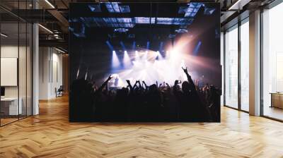 silhouettes of concert crowd in front of bright stage lights Wall mural