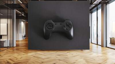 Gamepad in the middle of the black background. Wall mural