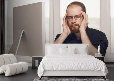 Stressed Man Working At Desk In Busy Wall mural