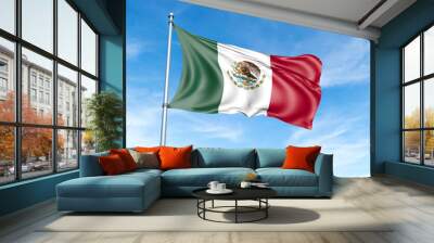 Mexico flag on a pole against a blue sky background. Wall mural