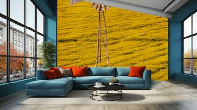 Windmill over canola field in the Flathead Valley of Montana Wall mural