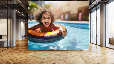 Happy little girl playing with colorful inflatable ring in outdoor swimming pool on hot summer day. Kids learn to swim. Child water toys. Children play in tropical resort. Family beach vacation. Wall mural