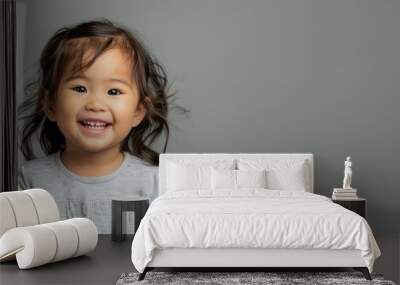 Portrait of a happy asian toddler girl smiling isolated on grey, banner Wall mural