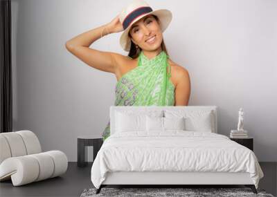 Portrait of happy young woman in summer clothing and straw hat isolated over white background. Wall mural