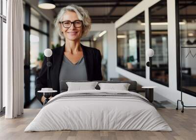 Portrait of middle age businesswoman standing with digital tablet at office. Business people. Wall mural