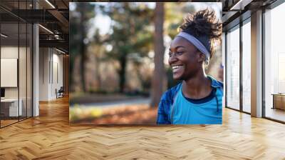 Portrait of sporty black woman runner running in a park Wall mural