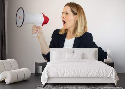 Pretty woman shouting into megaphone on copy space Wall mural