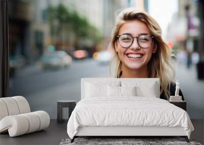 smiling young woman in eyeglasses over city street background Wall mural