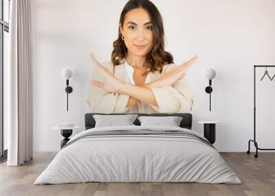 Woman making stop sign with crossed hands. Serious woman denying, refusing any action, looking at camera on white background Wall mural