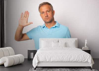 Young handsome man with blue eyes wearing casual clothes standing over white background doing stop sing with palm of the hand Wall mural