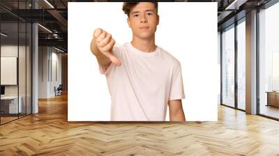 Young man wearing casual t-shirt standing over isolated transparent background looking unhappy and angry showing rejection and negative with thumb down gesture. Bad expression. Wall mural