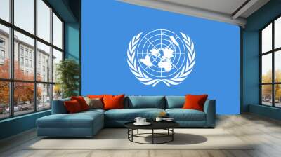 Flag of United Nations (UN), international territory, white UN emblem - polar azimuthal equidistant projection world map surrounded by two olive branches - on a blue background Wall mural